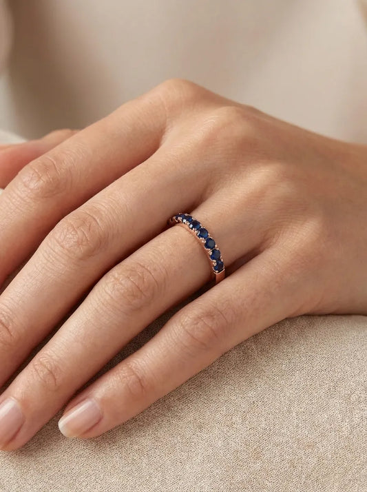 Red gold ring with blue sapphires