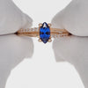 Red gold ring with blue zircon and side holes